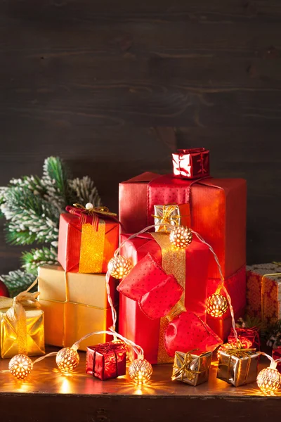 Red and golden christmas gift box and decoration lantern candle — Stock Photo, Image