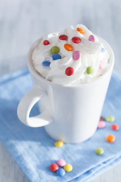 Coffee with whipped cream and colorful chocolate drops — Stock Photo, Image