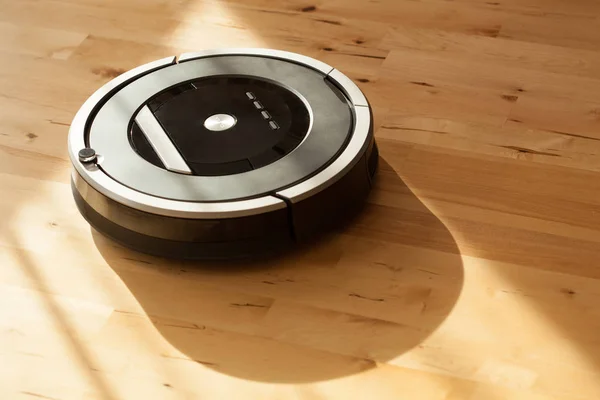 Robotic vacuum cleaner on laminate wood floor smart cleaning tec — Stock Photo, Image