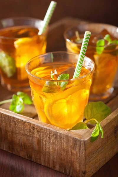 Ice tea with lemon and mint on dark rustic background — Stock Photo, Image