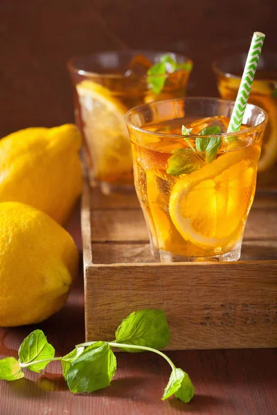 Ice tea with lemon and mint on dark rustic background — Stock Photo, Image