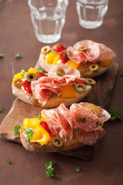 Salami bruschetta met gegrilde paprika geit kaas olijven — Stockfoto