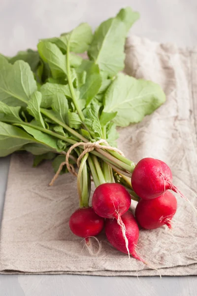 Fresh raw radish with leaves over gray background — Stock Photo, Image