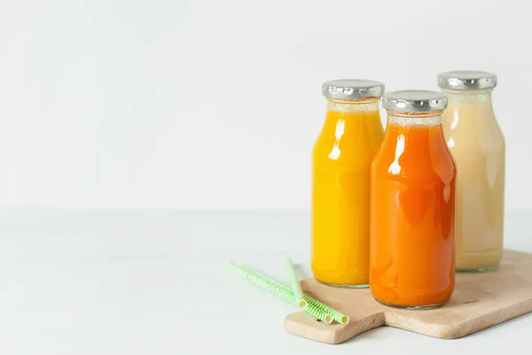 Batidos de frutas y verduras en frascos de vidrio, plátano de mango naranja —  Fotos de Stock