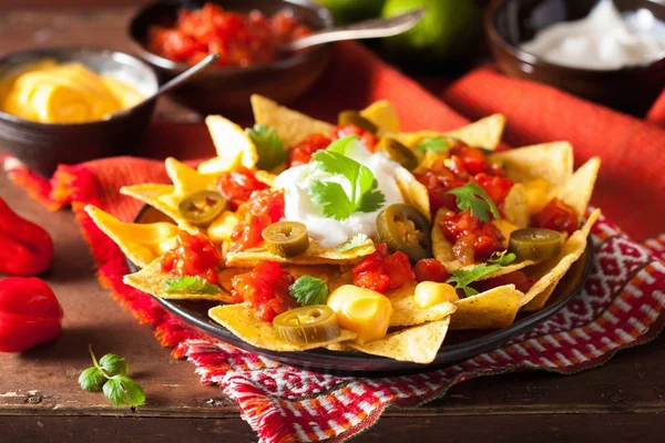 Nachos loaded with salsa, cheese and jalapeno — Stock Photo, Image