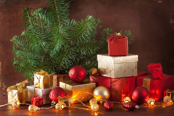 Boîte cadeau de Noël rouge et or et lumière de décoration — Photo