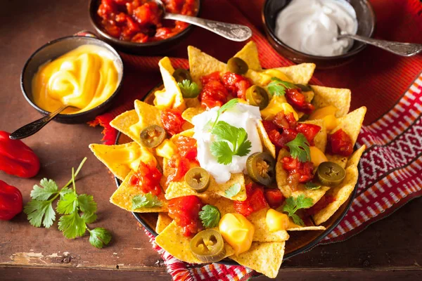 Nachos loaded with salsa, cheese and jalapeno — Stock Photo, Image