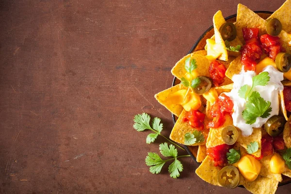 Nachos loaded with salsa, cheese and jalapeno — Stock Photo, Image