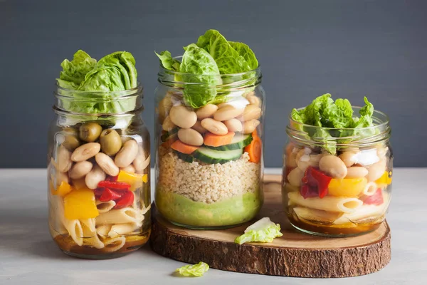 Vegan couscous and pasta salad in mason jars with vegetables bea — Stock Photo, Image