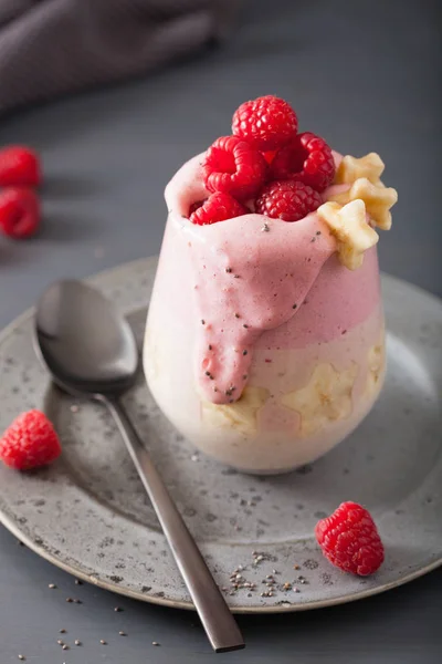 Healthy layered raspberry banana smoothie in glass — Stock Photo, Image