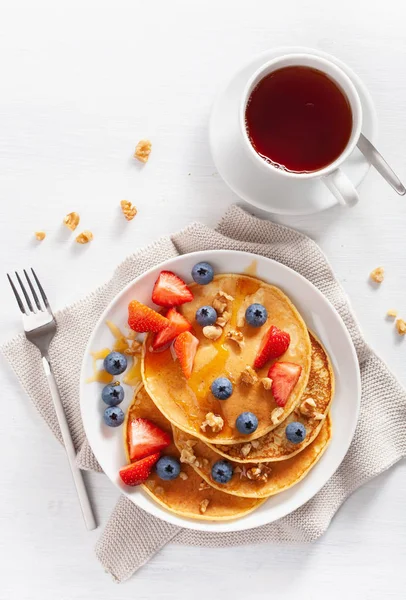 Pancake dengan madu blueberry strawberry dan kacang untuk sarapan — Stok Foto