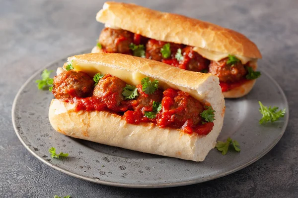 meatball sub sandwich with cheese and marinara tomato sauce. ame