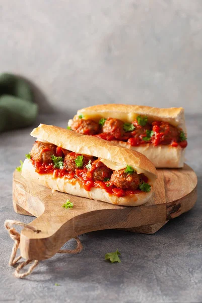 meatball sub sandwich with cheese and marinara tomato sauce. ame