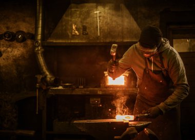 Blacksmith with brush handles the molten metal  clipart