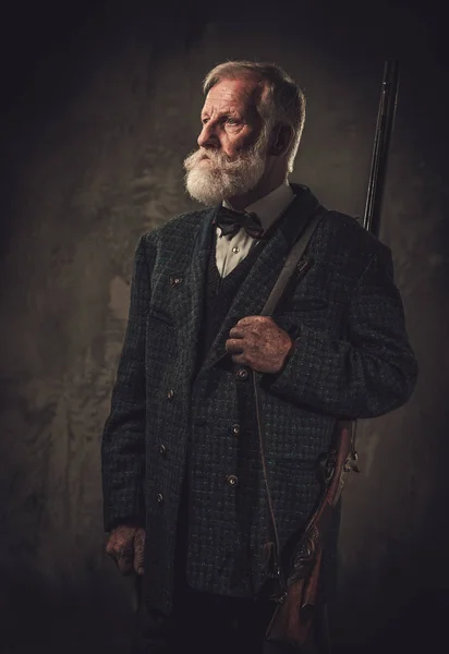 Cacciatore anziano con fucile in un tradizionale abbigliamento da tiro — Foto Stock