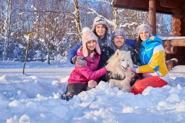 Cheerful friends with dog spend winter holidays together — Stock Photo, Image