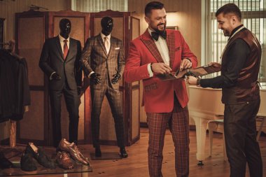 Extravagant man in tailor studio  clipart