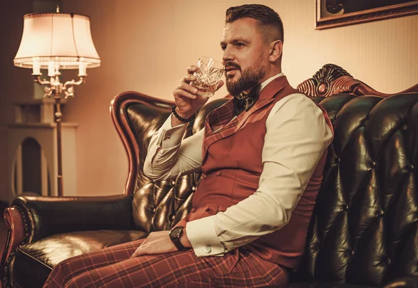 Extravagante hombre elegante con vaso de whisky — Foto de Stock