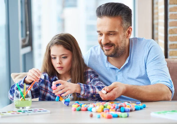 Menina bonita com seu pai brincando com conjunto colorido para a criatividade — Fotografia de Stock