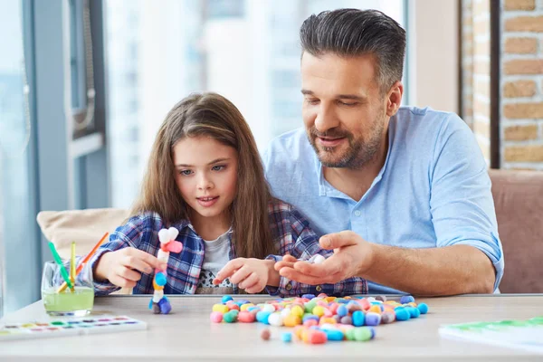 Vacker liten flicka med sin far som leker med färgade set för kreativitet — Stockfoto