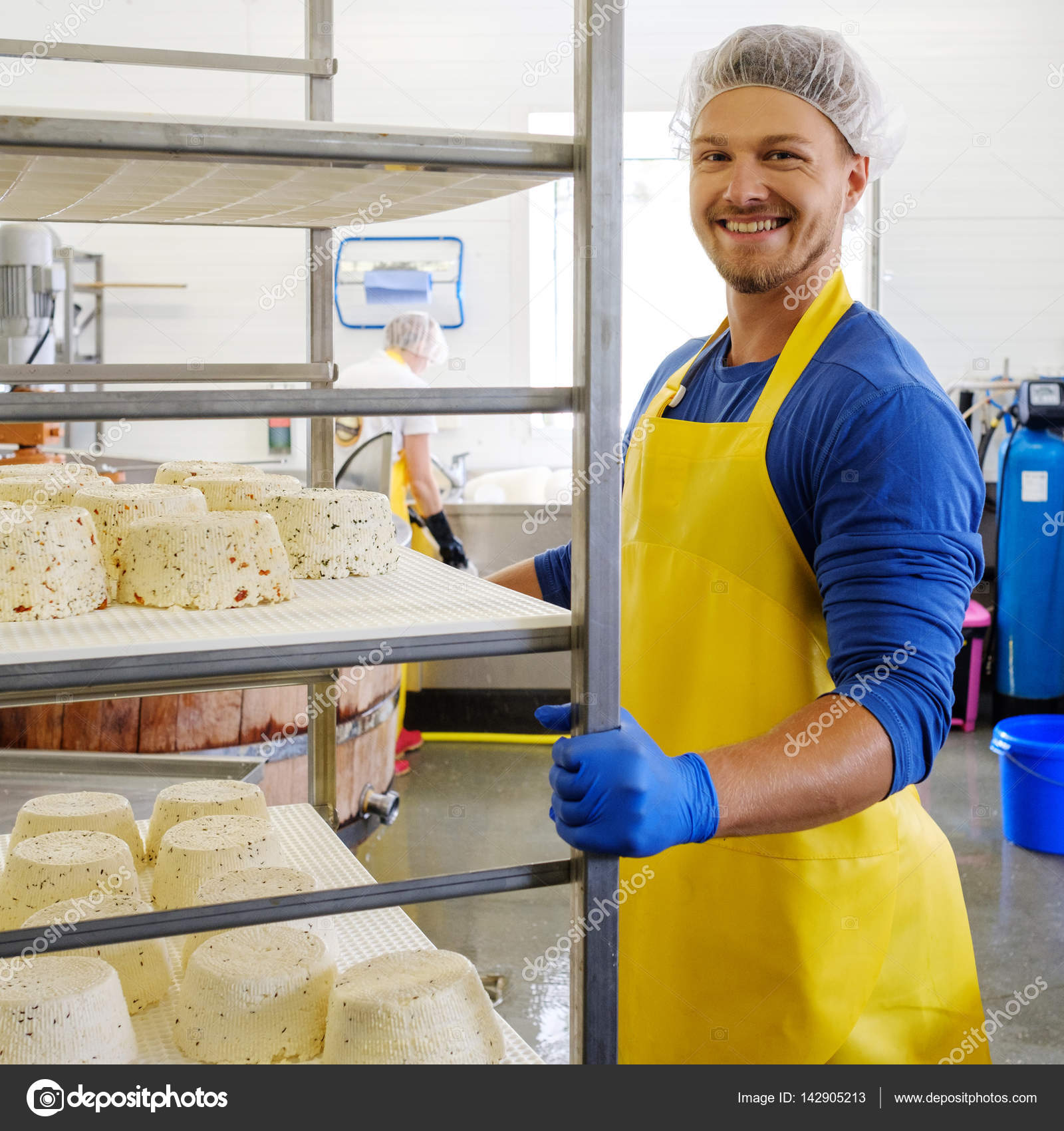 Handsome cheesemaker making curd cheese in his factory Stock Photo by ©nejron 142905213