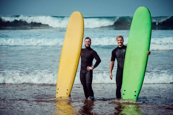 Surfer beginner en instructeur op een strand — Stockfoto