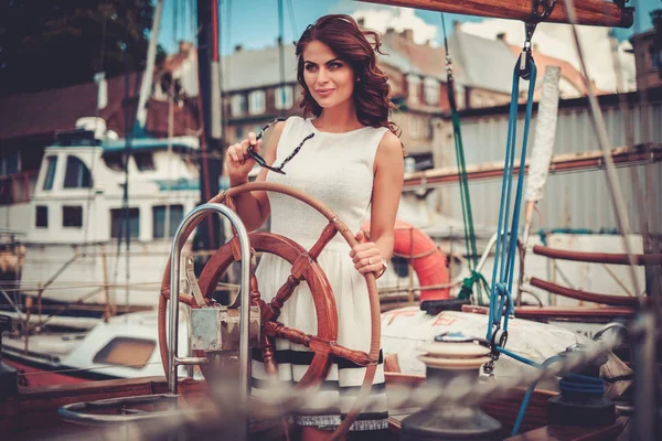 Stylische reiche Frau auf einer Luxus-Holzregatta — Stockfoto