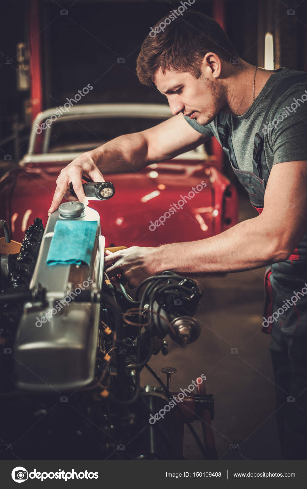 Mechanic working on classic car engine in restoration — Stock