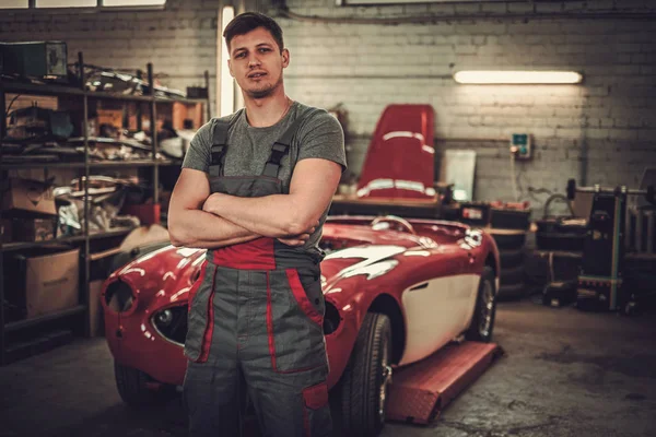 Mechanic in classic car restoration workshop