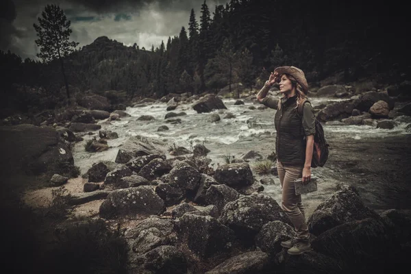 Belle randonneuse près de la rivière sauvage de montagne . — Photo