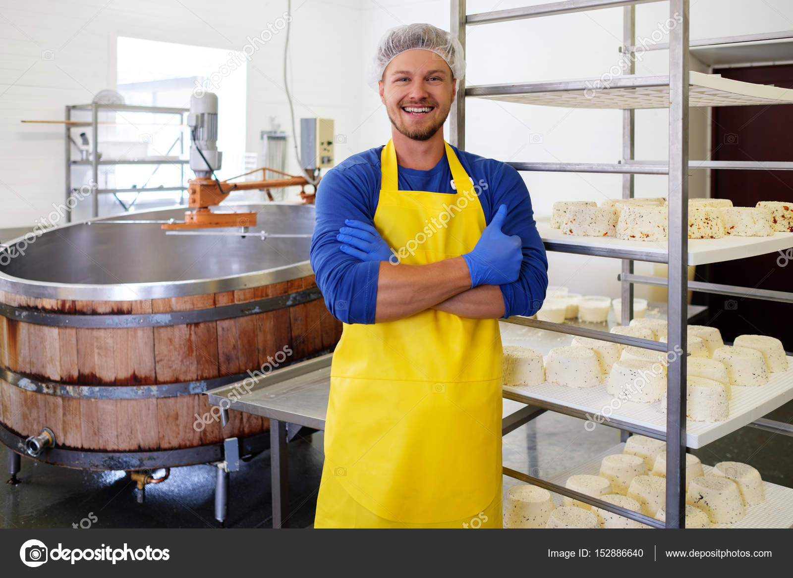 Handsome cheesemaker making curd cheese in his factory. — Stock Photo