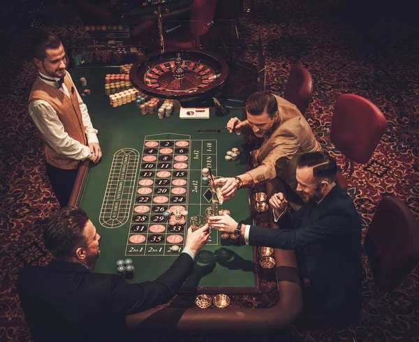 Upper class friends gambling in a casino