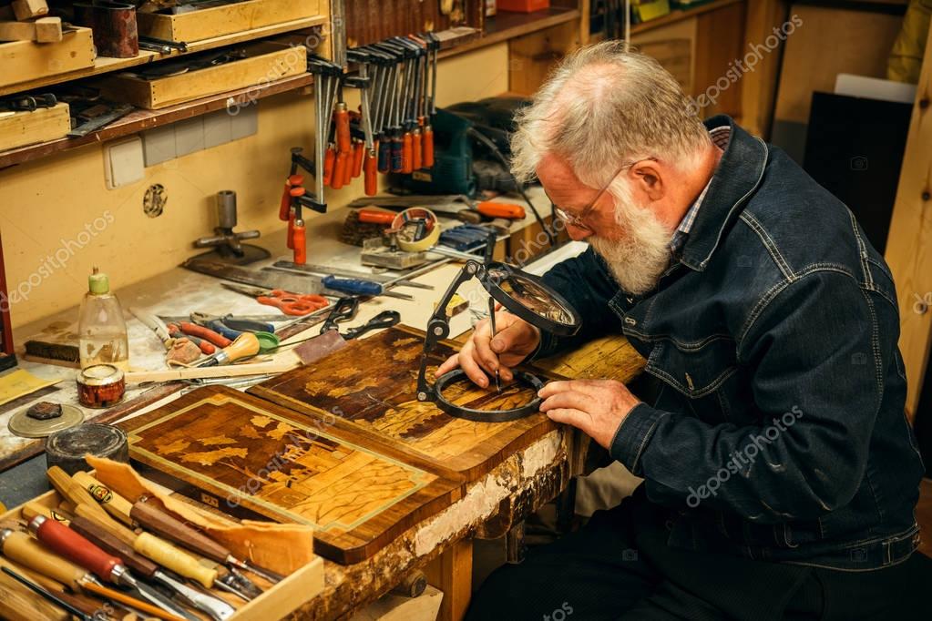 Senior wood carving professional during work — Stock Photo © nejron