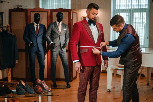 Tailor measuring client for custom made suit tailoring. — Stock Photo, Image