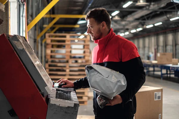 Courier picks up package on a warehouse — 스톡 사진