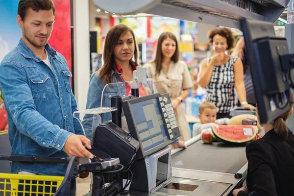 Pareja comprando bienes en una tienda de comestibles —  Fotos de Stock