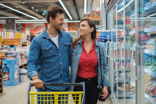 Casal escolher bens em uma mercearia — Fotografia de Stock