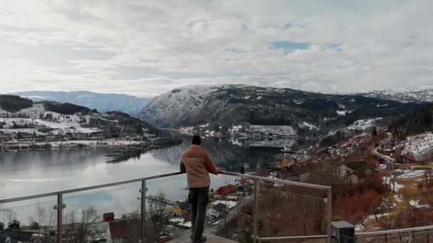 Man kijkt uit over Hardangerfjord vanaf het terras van het huis, Noorwegen. — Stockvideo