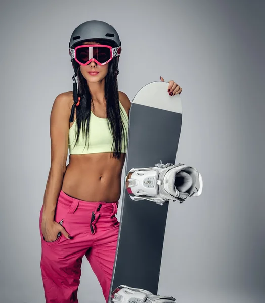 Sonriente morena hembra sosteniendo snowboard — Foto de Stock