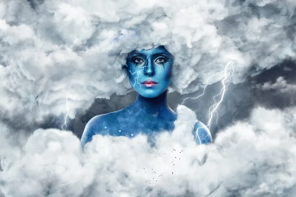 Female with blue skin in an arch of white clouds — Stock Photo, Image