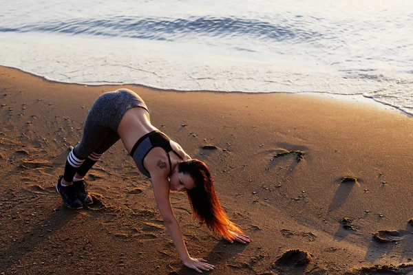 Fitness feminino exercitando em uma praia — Fotografia de Stock