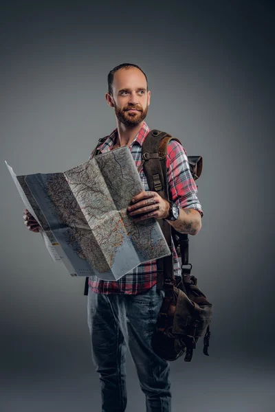 Tourist male holding city map