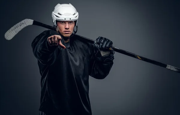 Hockey player holds gaming stick