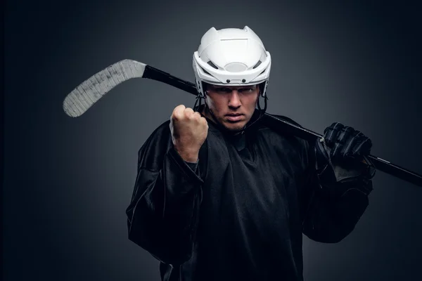 Hockey player holds gaming stick — Stock Photo, Image