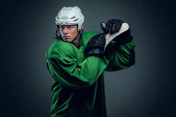 Hockey player holds gaming stick