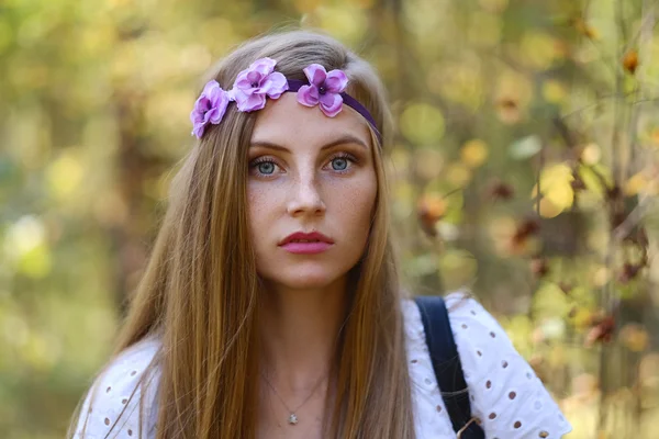 Freckled woman with circlet of flowers — Stock Photo, Image