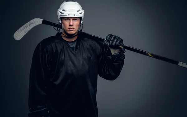 Hockey player holds gaming stick — Stock Photo, Image