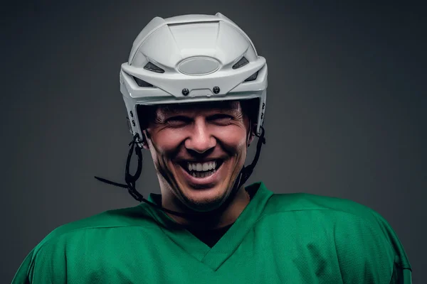 Portrait of hockey player on grey background. — Stock Photo, Image