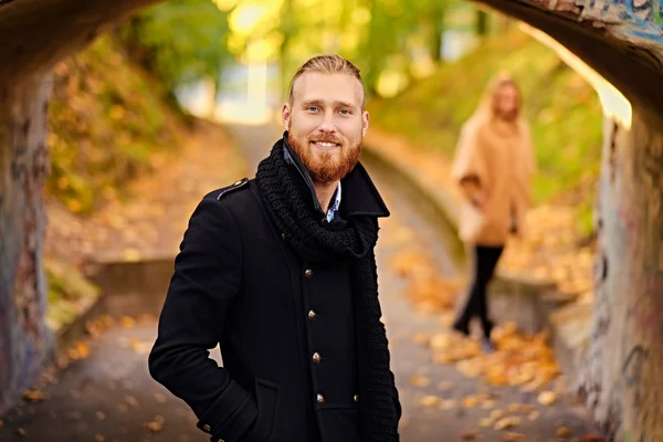 Smiling redhead male in a warm jacket