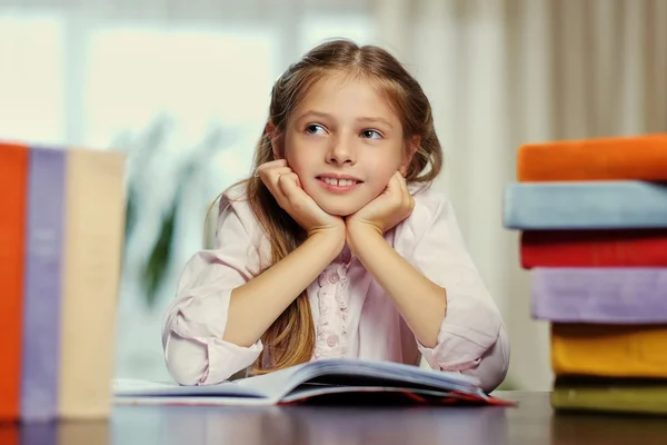 Positive little girl likes reading Stock Photo